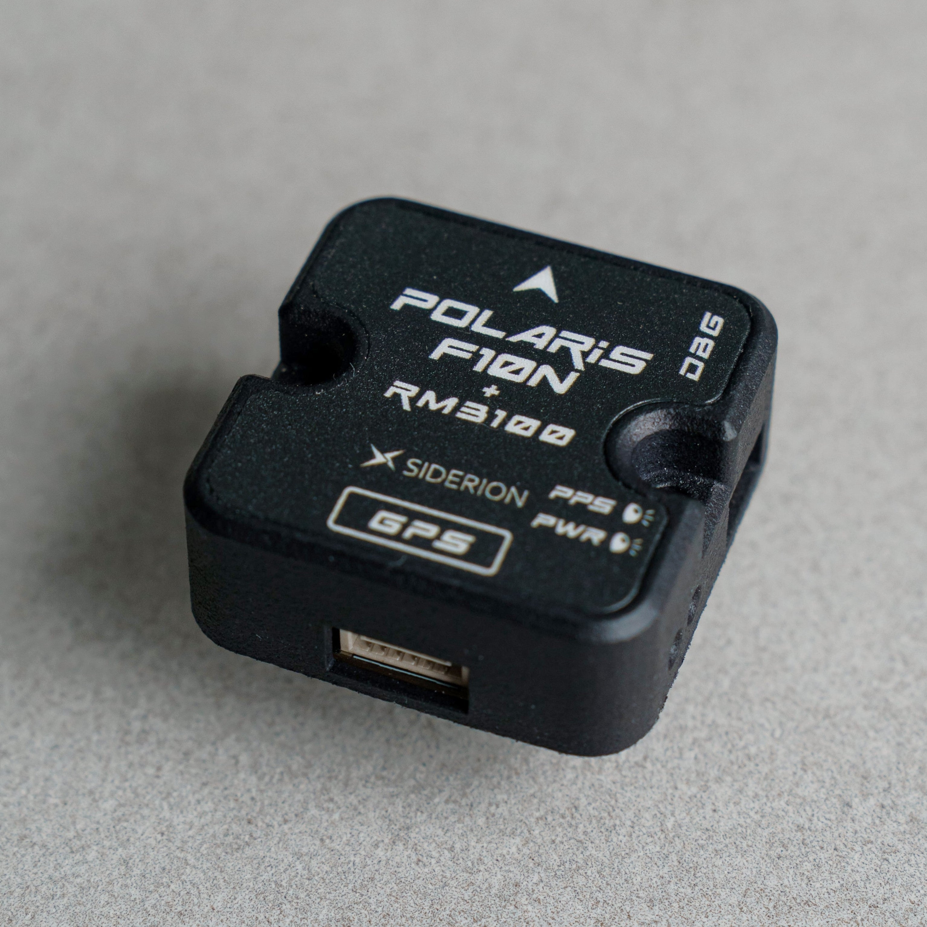 Siderion Polaris F10N standard GNSS device on a gray background