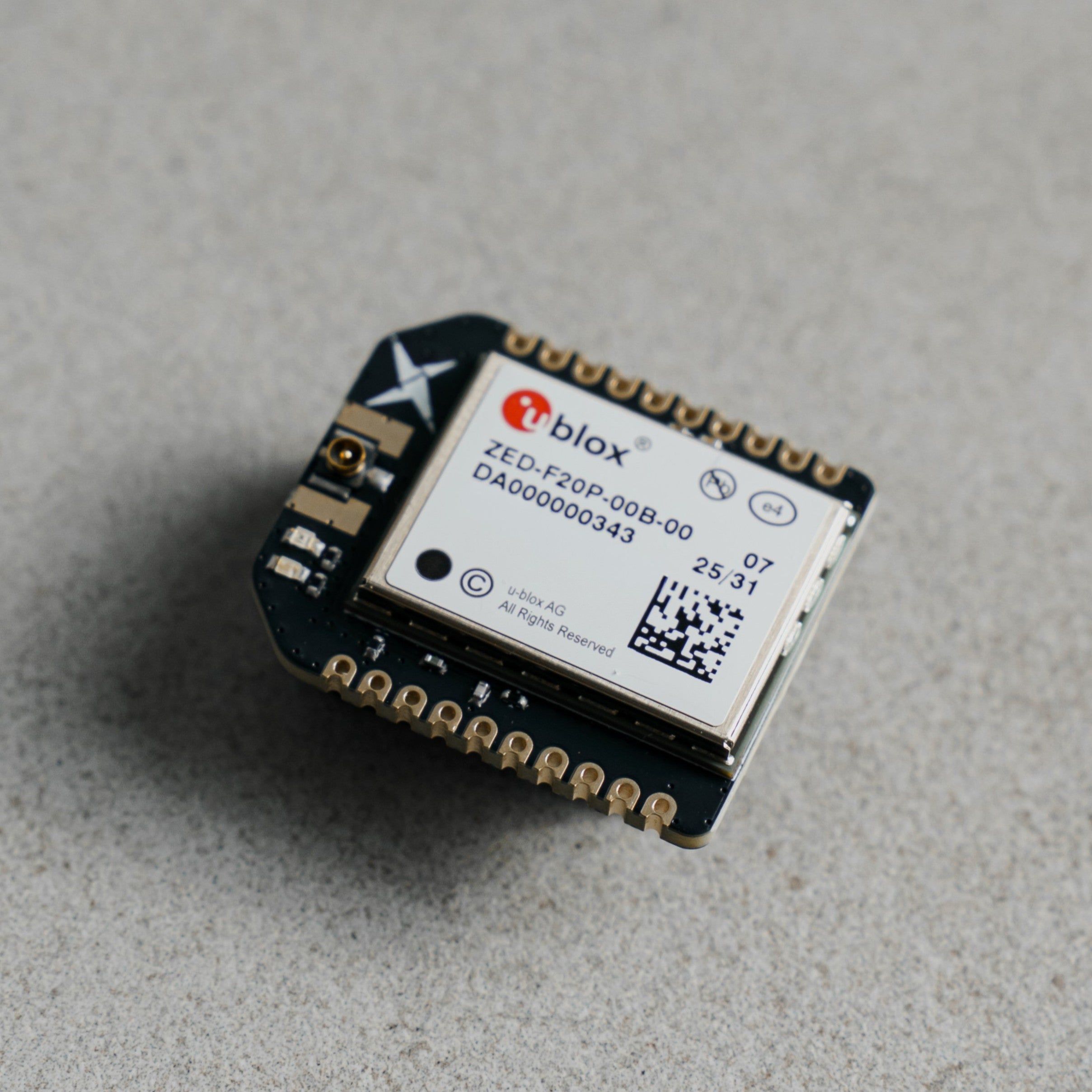 Siderion SP0700 ZED-F20P RTK GNSS device with u.FL connector, on a gray background.