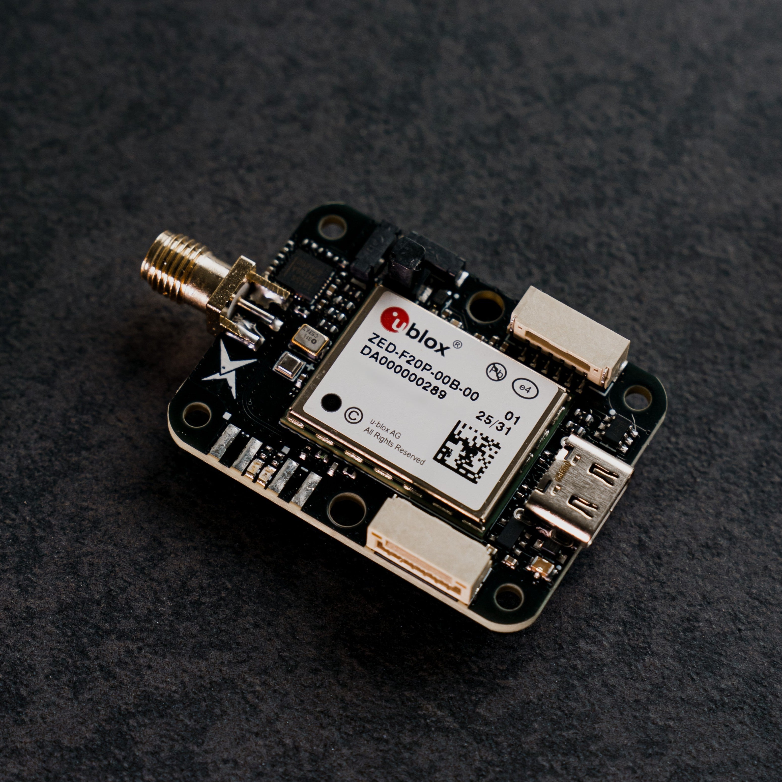 Siderion SP0703 ZED-F20P RTK GNSS module on a dark background. Top view.