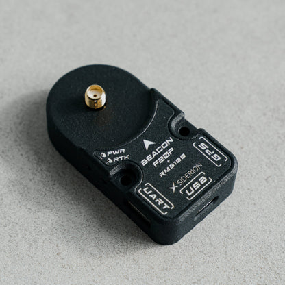 Siderion BeaconF20P RTK GNSS module based on the ZED-F20P on a gray background. Top isometric view.