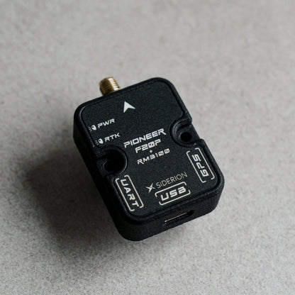 Siderion PioneerF20P RTK GNSS module based on the ZED-F20P on a dark gray background. Top view.
