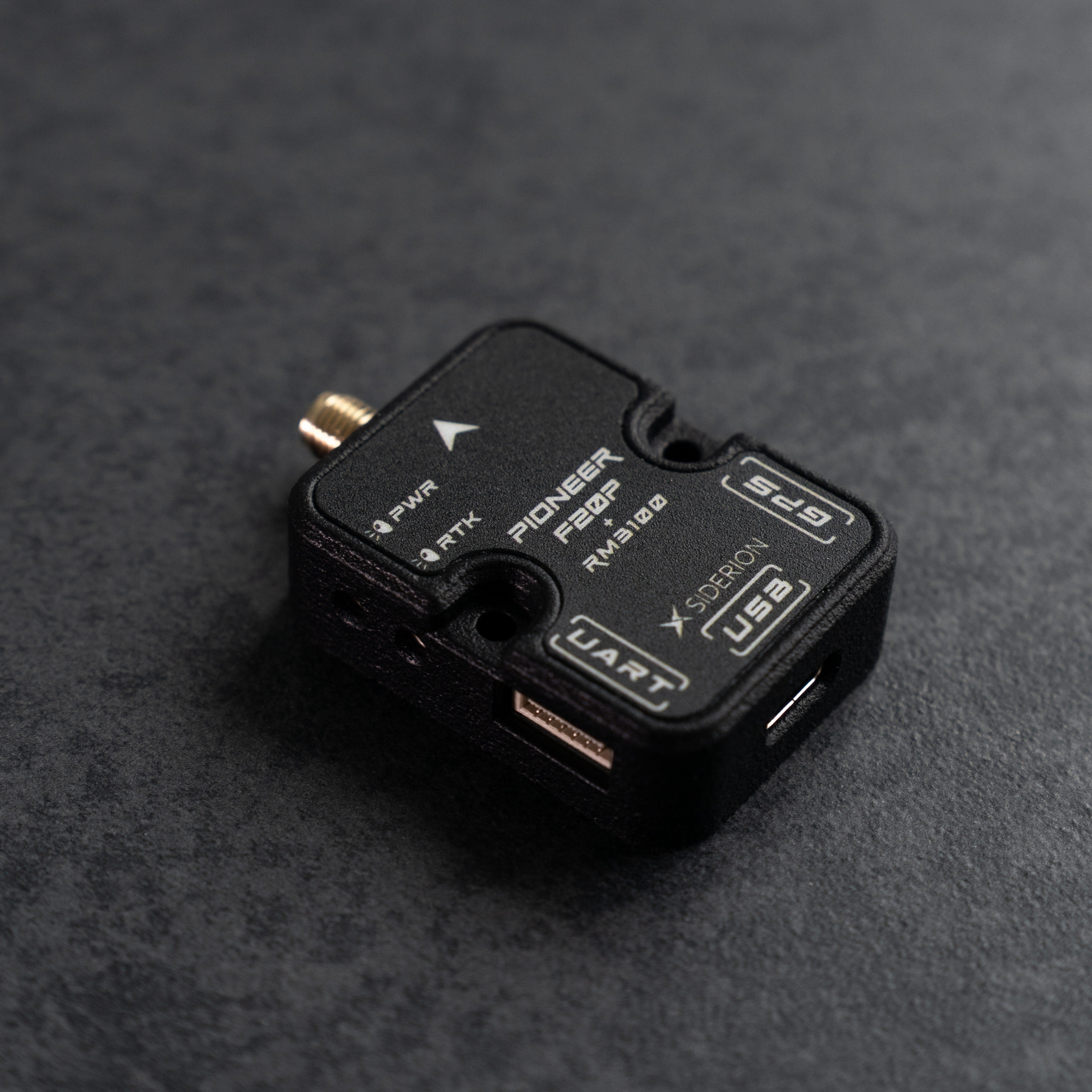 Siderion PioneerF20P RTK GNSS based on the ZED-F20P module on a dark gray background. Top isometric view.