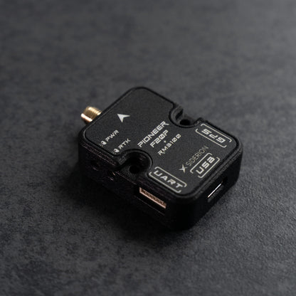 Siderion PioneerF20P RTK GNSS based on the ZED-F20P module on a dark gray background. Top isometric view.