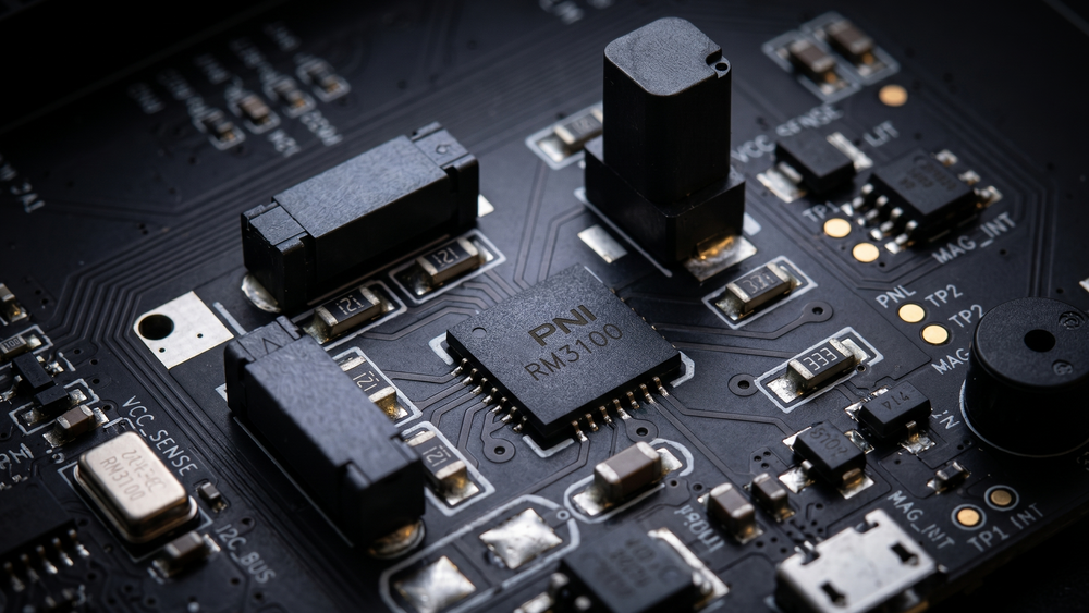 Close-up of a circuit board with electronic components on a dark background