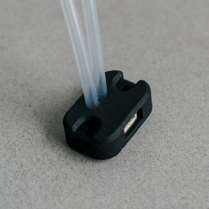 Siderion SDP33 Airspeed differential pressure sensor on a gray background. Silicone tubes are pointing up.